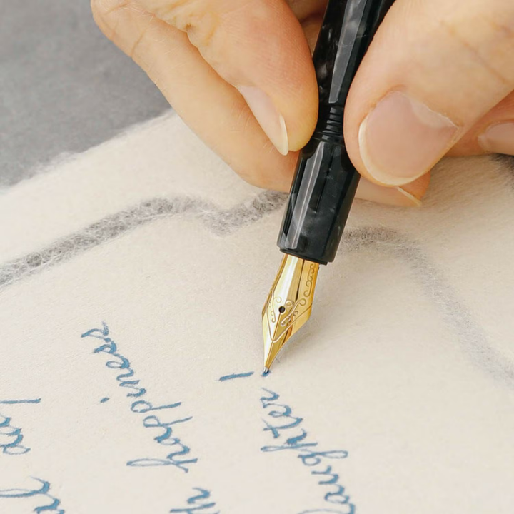 Hightide Attaché Marbled Fountain Pen - Black — writing at an angle