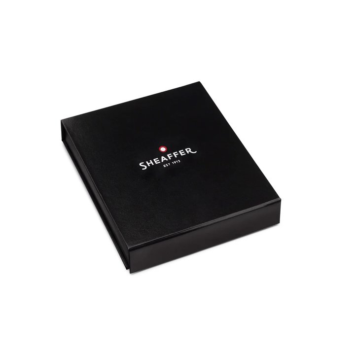 Sheaffer Gift Set ft. Glossy Black 100 Ballpoint Pen with Chrome Trims and Business Card Holder — writing at an angle