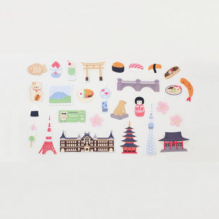 Suatelier Sticker – Tokyo Travel Diary featuring 28 illustrated Tokyo motifs such as landmarks, street food, and city scenes on a 15×17 cm coated paper sheet.