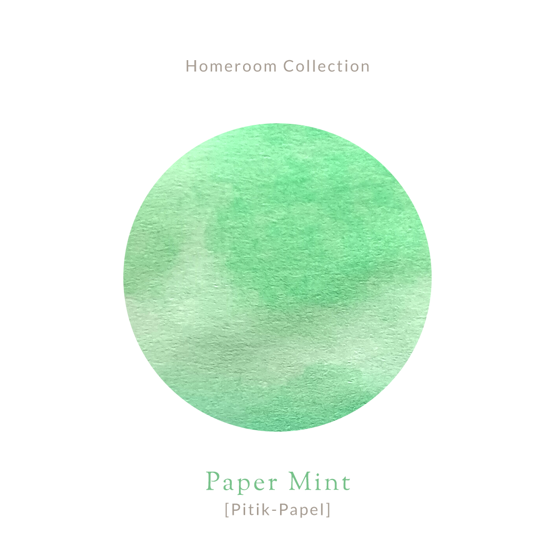 Amber glass bottle of Vinta Inks 30ml in the shade “Paper Mint [Pitik-Papel],” a light mint green ink. The bottle features a charming, nostalgic label and sits next to a swatch of the fresh, playful green ink on white paper.