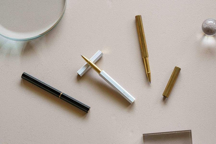 Ystudio Classic Revolve Rollerball Pen - White — flat lay