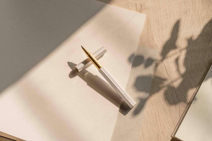 Ystudio Classic Revolve Rollerball Pen - White — flat lay